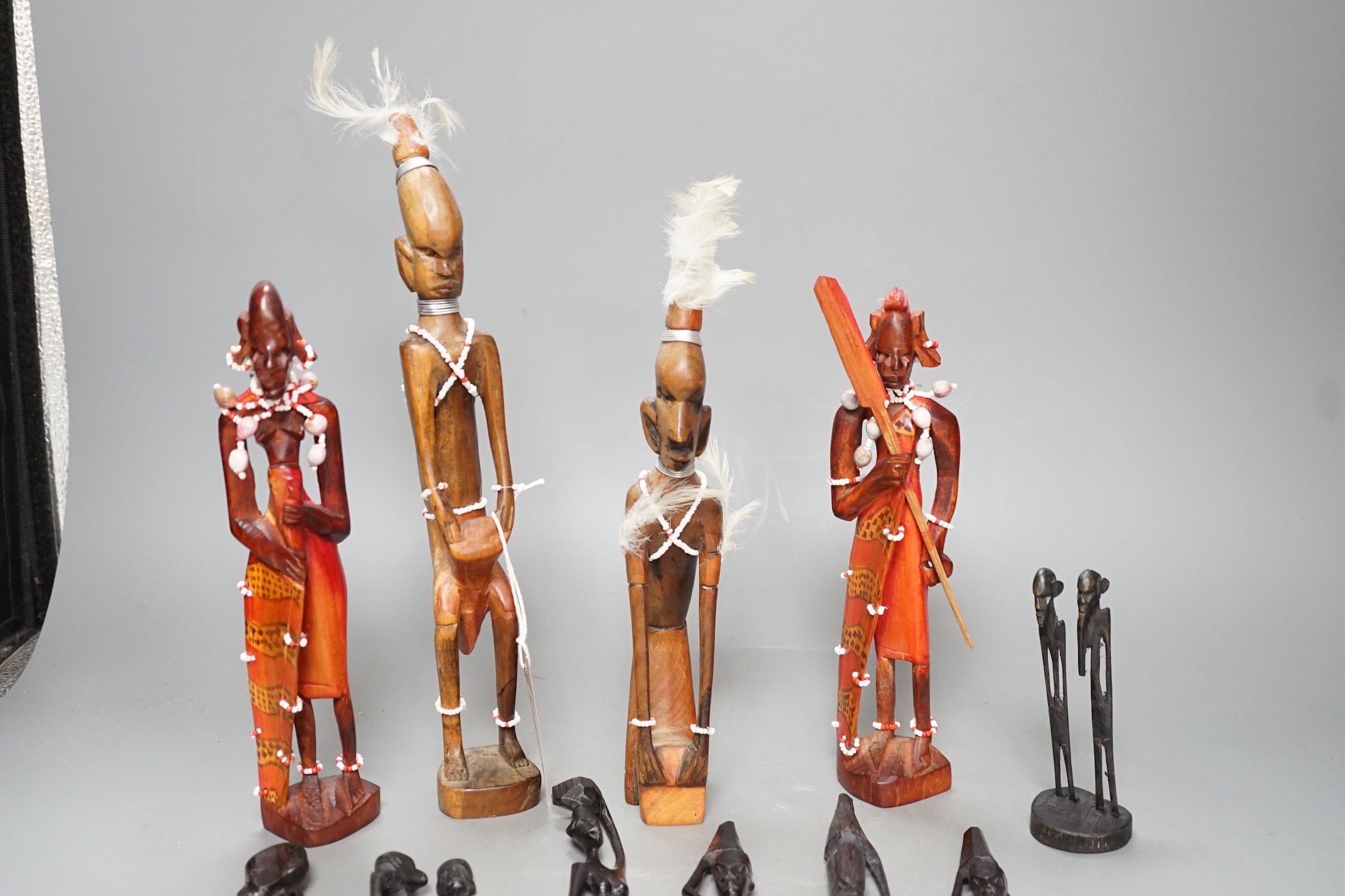12 African carved wood stick figures, tallest 38cms high